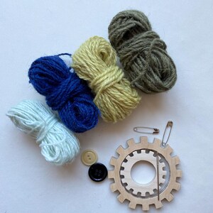 green and blue yarn, wooden flower looms, needle and buttons