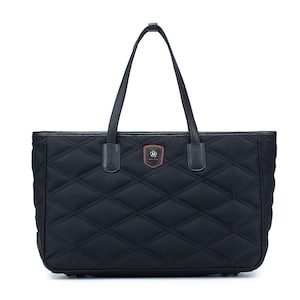 May include: Black quilted tote bag with a brown leather logo patch and black leather handles.