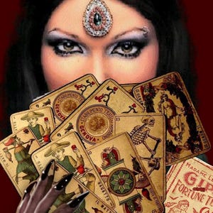 May include: A woman with dark hair and dramatic eye makeup holds a fan of vintage tarot cards. The cards feature illustrations and Italian text, with a booklet labeled "Madame Le Gipsy Fortune Telling Cards".