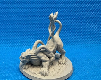 May include: A light gray, unpainted 3D printed miniature of a quadrupedal creature with multiple tentacles emerging from its back and a single, open-mouthed plant-like appendage rising vertically from its rear, all mounted on a circular base.