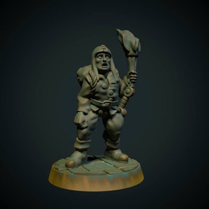 May include: A green and brown painted miniature figurine of a dwarf holding a torch. The dwarf is wearing a hat and has a beard. The figurine is standing on a round base.