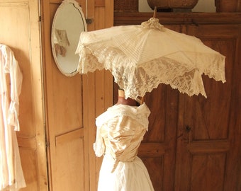 Antique edwardian cotton/silk parasol with double lace flounces in a creamy beige colour.