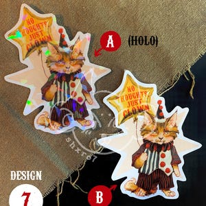 K&ouml;nnte beinhalten: Zwei holografische Aufkleber mit einem Cartoon-Katzen-Clown, der einen sternf&ouml;rmigen Ballon mit dem Text "No Thoughts Just Clown" h&auml;lt. Die Aufkleber sind 9,8 cm x 7,8 cm gro&szlig;.
