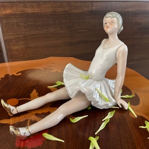 Very elegant sculpture of a seated ballerina, porcelain figurine, ballet, home decoration, Elegant shape, lifelike expression details