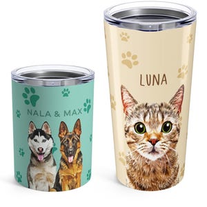 May include: A short teal tumbler featuring a husky and a German shepherd with the text NALA & MAX and a tall beige tumbler featuring a tabby cat with the text LUNA. Both tumblers have clear lids and are decorated with scattered paw print patterns.