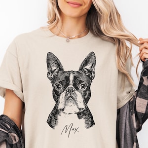 Custom pet portrait t-shirt featuring a black and white Boston Terrier illustration with pet name 'Max', personalized dog lover gift on sand beige unisex shirt, perfect for memorial or pet owner gift.