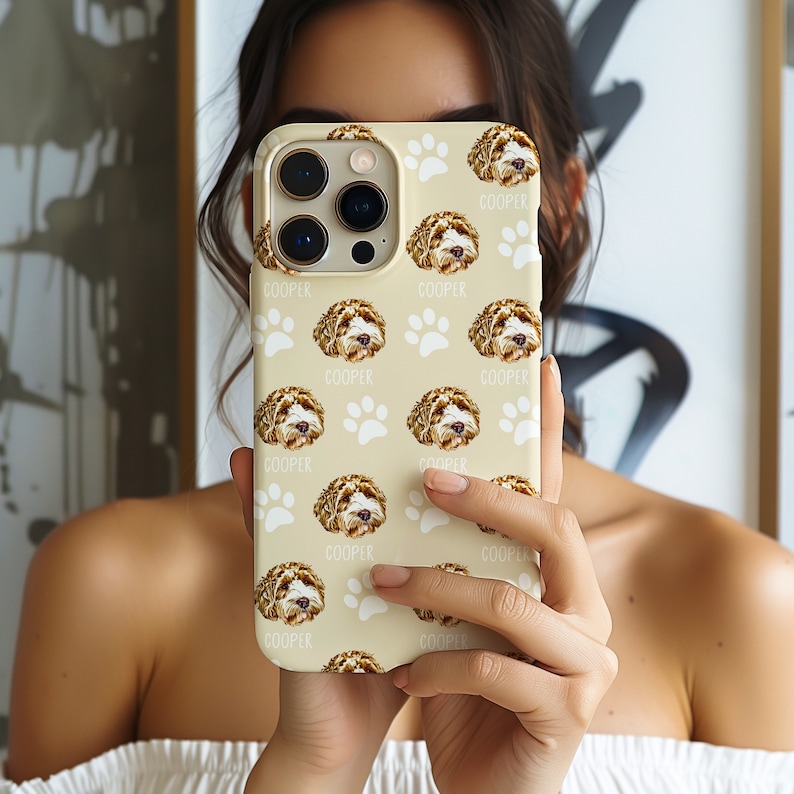 Custom pet phone case with a personalized dog illustration, name 'Cooper,' and paw print design. Fits various models, including iPhone 16. A unique gift for dog lovers or a thoughtful pet memorial.
