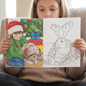 May include: A coloring book open to two pages. One page shows a girl in a Santa hat and green sweater with a dog and Christmas tree. The other page shows a dog wearing reindeer antlers and a plaid blanket.