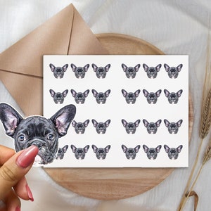 May include: A sheet of stickers featuring a repeated pattern of black French bulldog faces. The stickers are on a white background.