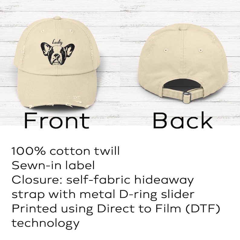 May include: A beige baseball cap with a distressed brim and a black graphic of a French bulldog face with the word Lucky printed above it. The back view shows a self-fabric strap with a metal D-ring slider for an adjustable fit and closure.