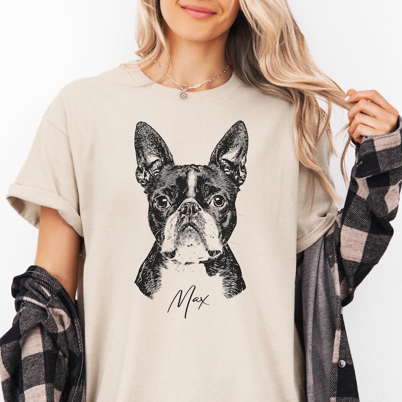Custom pet portrait t-shirt featuring a black and white Boston Terrier illustration with pet name 'Max', personalized dog lover gift on sand beige unisex shirt, perfect for memorial or pet owner gift.