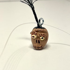 Cabeça encolhida, suco de besouro, enfeite, miniatura