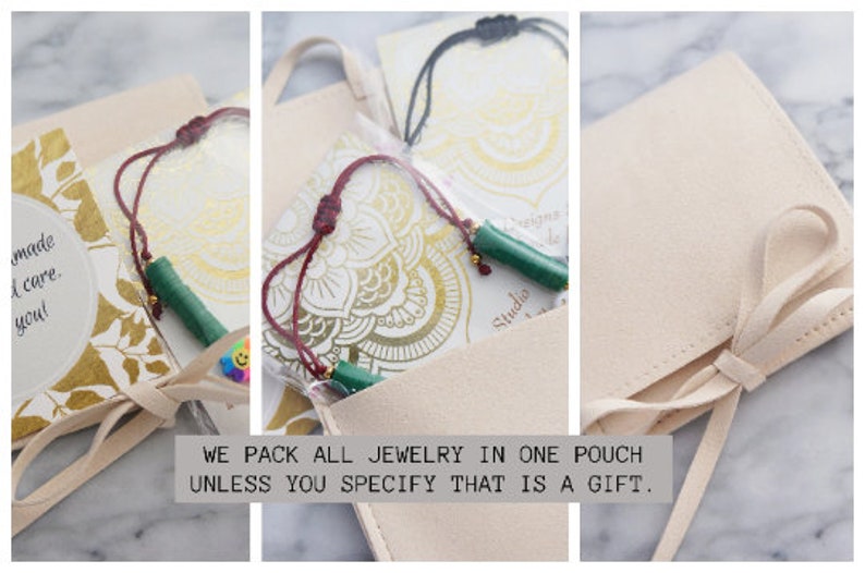 May include: A close-up of a beige suede pouch with a tied ribbon closure. The pouch contains jewelry, including a green beaded necklace and a black cord necklace. The pouch is on a marble surface. The text "WE PACK ALL JEWELRY IN ONE POUCH UNLESS YOU SPECIFY THAT IS A GIFT." is printed below the pouch.