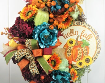 Beautiful fall wreath, with sunflowers, teal ,burgundy, creams and oranges to make your front door scream fall