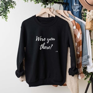 Op de afbeelding: Zwart sweatshirt met de tekst "Were you there?" in witte letters.