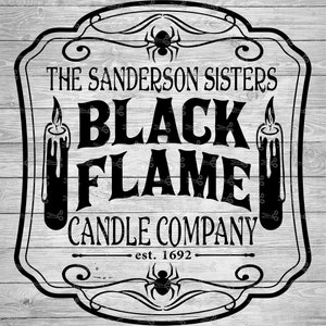May include: Black and white sign with the text "The Sanderson Sisters Black Flame Candle Company est. 1692" with two black candles and a black spider on a white wood background.