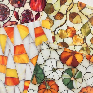 May include: A collection of decorative glass panels with stained glass designs. The panels feature images of pomegranates, autumn leaves, candy corn, and pumpkins in shades of red, orange, yellow, green, and white.