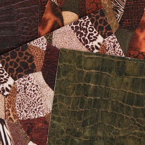 May include: A collection of overlapping rectangular sheets featuring various animal print patterns including leopard spots, zebra stripes, and textured crocodile skin in shades of brown, black, tan, white, and olive green with a matte finish.