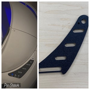 May include: A white automatic self-cleaning cat litter box with a blue light and a control panel with buttons labeled "scoop", "setting", "time", "feed", "manual", and "cycle". A black plastic bracket with five holes is shown in the right side of the image.