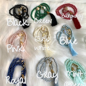 May include: Ten different colors of prayer beads with tassels. The colors are black, green, burgundy, pink, ecru white, blue, royal blue, gray, and mint green.