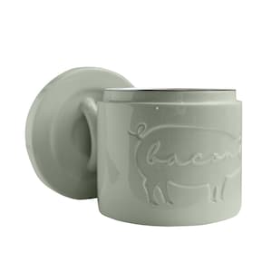 May include: A sage green ceramic canister with a lid, featuring an embossed pig with the word "bacon" written on it.