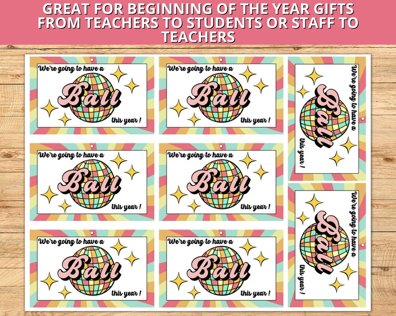 May include: Six colorful gift tags with a disco ball design and the text "We're going to have a ball this year!"
