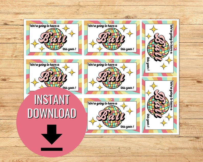 May include: Six printable cards with a retro design featuring a disco ball and the text "We're going to have a Ball this year!" in a pink and yellow font.