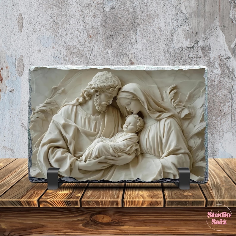 May include: A stone plaque featuring a relief sculpture of the Holy Family. The sculpture depicts Mary, Joseph, and baby Jesus. The sculpture is white and is set against a light brown background.