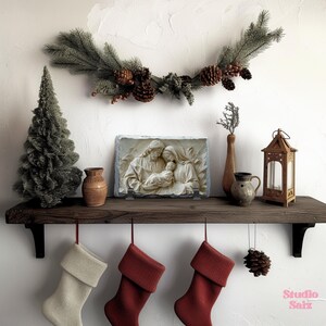 May include: A white stone plaque featuring a relief sculpture of the Holy Family. The sculpture depicts Mary, Joseph, and baby Jesus. The plaque is mounted on a wooden shelf with a Christmas garland above it. There are three stockings hanging from the shelf, two red and one white.