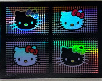 Holografisk kattunge|Flerfärgad kattunge|Egent klistermärke|Söt kattunge|Kittungepresent|Röd rosett kattunge|Söt katt|Hello|Kitty|Laptopdekal|Vattenflaska|Dekal
