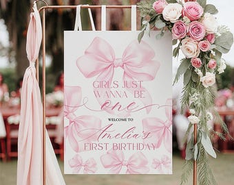 Peut inclure: Panneau de bienvenue pour un premier anniversaire. Le panneau blanc est orné de nœuds roses et du texte « Girls Just Wanna Be One » et « Bienvenue à Amelia's First Birthday ». Décoré de roses roses et de verdure.