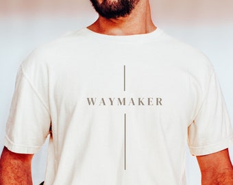 May include: A white t-shirt with a vertical line and the text "WAYMAKER" printed on the front.