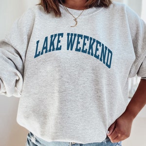 May include: Gray sweatshirt with the text "LAKE WEEKEND" in blue lettering.