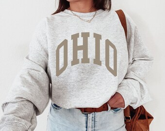 May include: A grey sweatshirt with a large, brown, arched "OHIO" graphic.