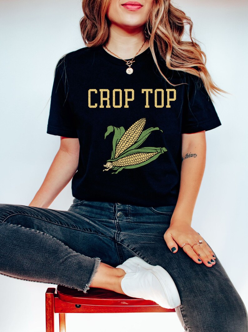 May include: A black crop top with the text "CROP TOP" in yellow letters and a green and yellow corn graphic.
