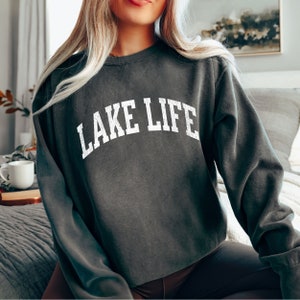 May include: A dark gray sweatshirt with the text "LAKE LIFE" printed in white on the front.