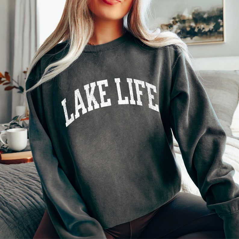 May include: A dark gray sweatshirt with the text "LAKE LIFE" printed in white on the front.