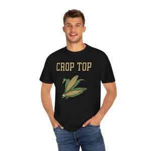 May include: A black t-shirt with the text "CROP TOP" in yellow letters and a graphic of a corn cob with green husks.