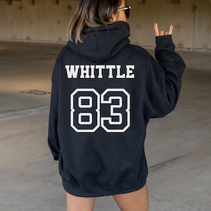 May include: Black hooded sweatshirt with the text "WHITTLE 83" printed in white on the back.