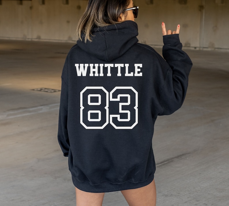 May include: Black hooded sweatshirt with the text "WHITTLE 83" printed in white on the back.