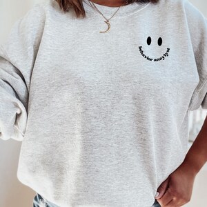 May include: Gray sweatshirt with a black smiley face graphic and the text "behavior analyst" written around the smile.