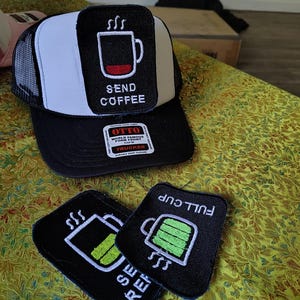 May include: A black and white trucker hat with a rectangular patch featuring a coffee mug icon and the text SEND COFFEE. Two additional rectangular patches are included, one showing a coffee mug with a green battery level and the text FULL CUP.