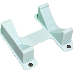 May include: A light blue plastic stand with two raised sections on each side. The stand has two black screws on the bottom.