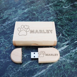 May include: A wooden USB drive with a paw print and the name "MARLEY" engraved on it. The drive is in a wooden box with the same engraving.