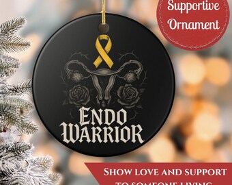 May include: Black round ornament with a yellow ribbon, uterus graphic, and the words "Endo Warrior." The ornament has a gold string for hanging. The text "Show love and support to someone living with endometriosis" is also present.