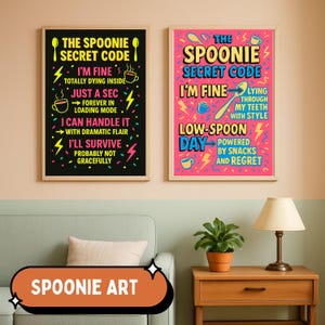 May include: Two framed art prints with the text "The Spoonie Secret Code" in yellow, pink, and blue. The black print includes phrases like "I'm fine, totally dying inside." The pink print says "Low-Spoon Day, powered by snacks and regret."