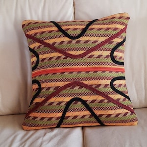 Orange, rust and yellow stripes with rust and black &quot;mountains and hills&quot; applique retired rope throw pillow.