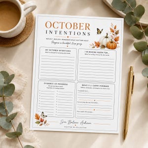 Op de afbeelding: Een wit papieren plannerblad met de titel October Intentions met secties voor doelen, voortgang en reflecties. Het bevat illustraties van pompoenen, herfstbladeren en vlinders, met de tekst See Believe Achieve onderaan de pagina.