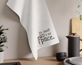 May include: White kitchen towel with the text "He himself is our peace." and a pink and white bird illustration.