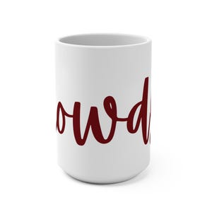 May include: A white ceramic mug with the word "owd" in a burgundy script font. The mug is cylindrical and has a simple, clean design. The text is centered on the mug.